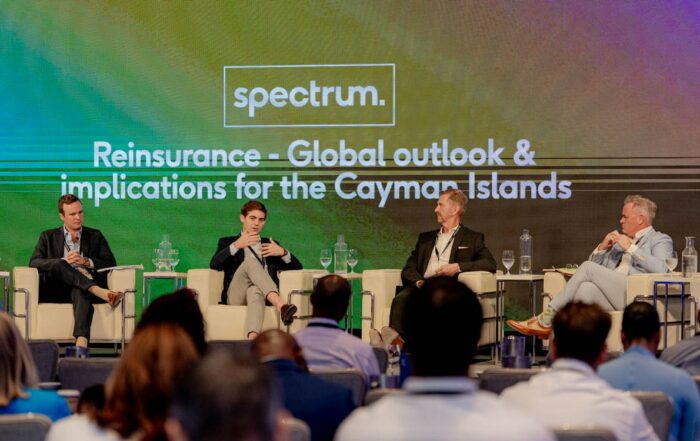 Photo of four speakers on the Reinsurance Panel at Spectrum 2023