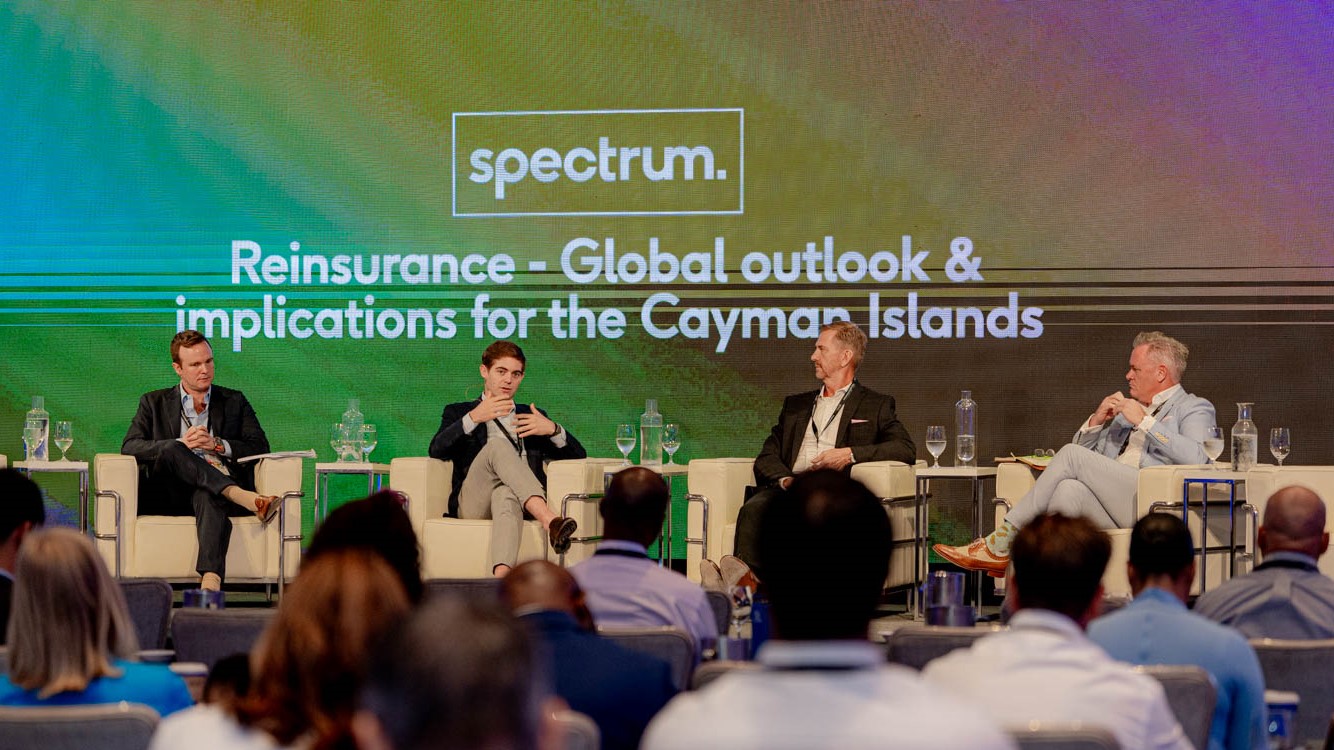 Photo of four speakers on the Reinsurance Panel at Spectrum 2023